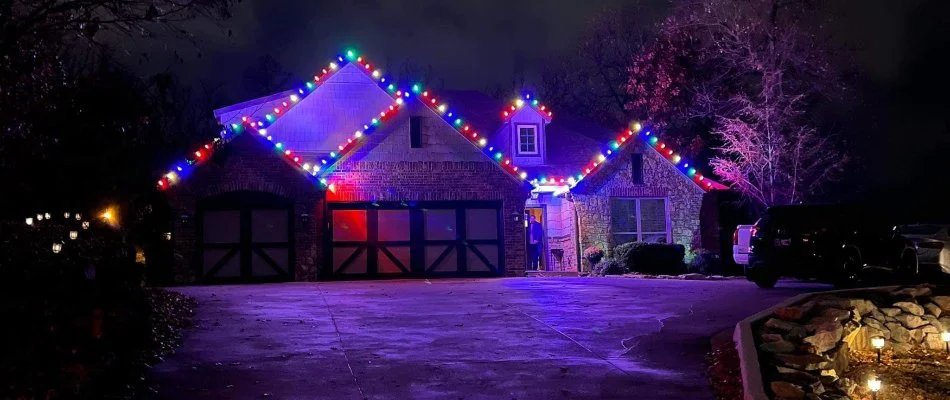 Colored holiday lights along the eaves of a house in Tulsa, OK.