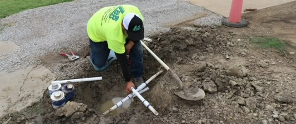 Crew inspecting damaged irrigation lines in Tulsa, OK.