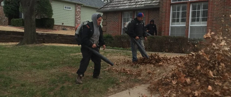 Crew removing leaves from a lawn in Collinsville, OK.