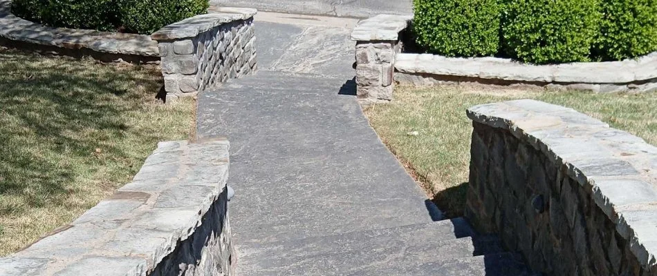 Outdoor steps in Oakhurst, OK, lined with grass and shrubs.