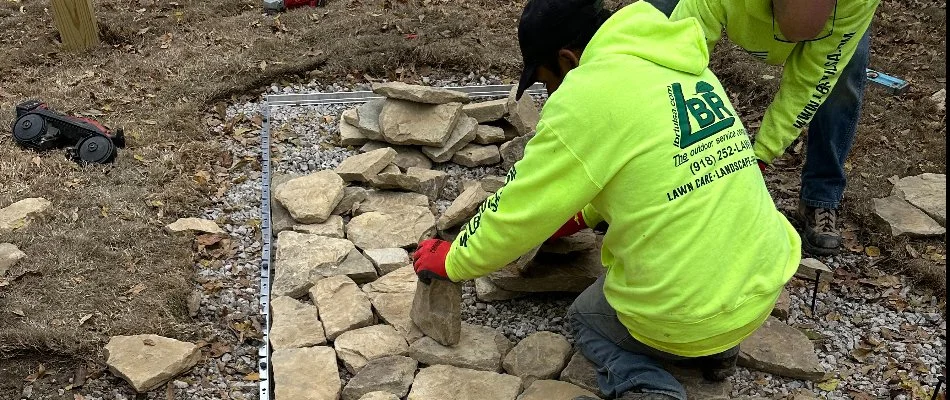 Workers in Collinsville, OK, installing stones for outdoor living.